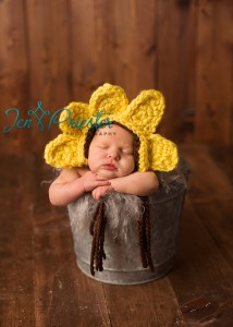 Newborn Girl Posed In Flower Hat Bucket 214x300