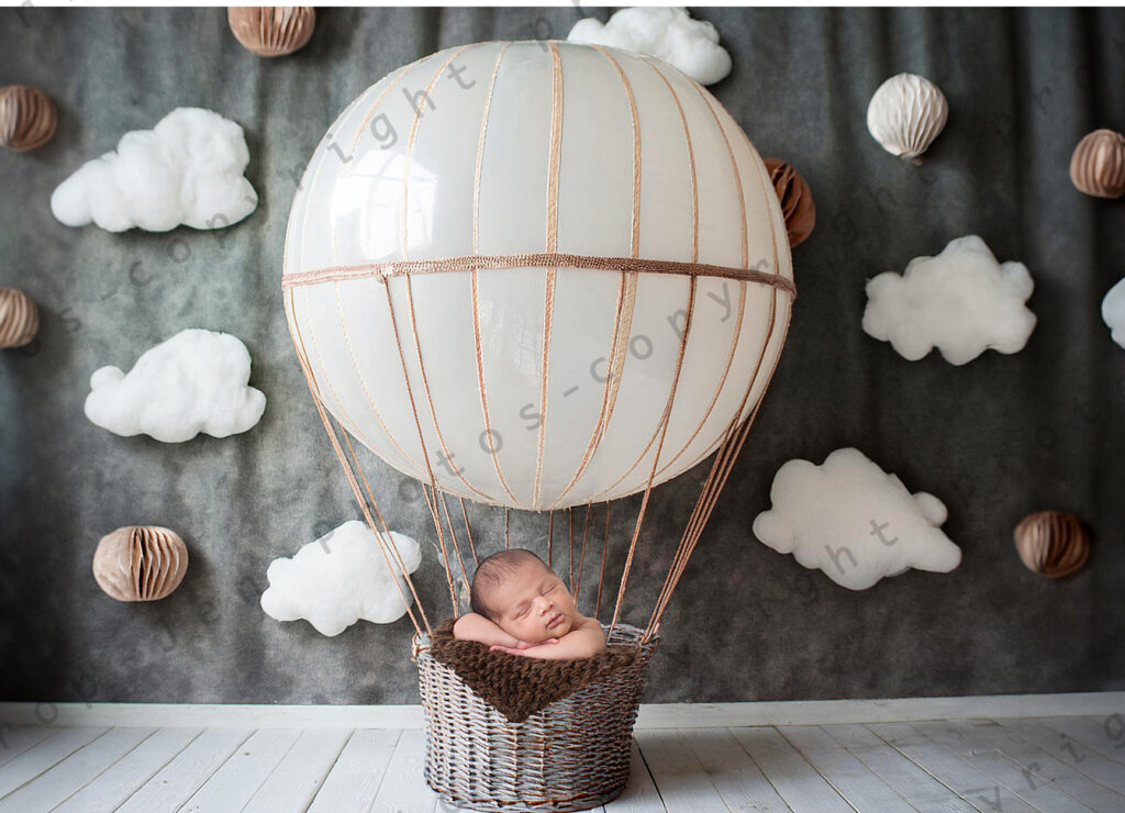 Newborn baby in hot air balloon prop and bucket for newborn photoshoot by Jen Photos, Upstate Newborn Photographer in Greenville, SC